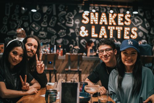 Four patrons sitting at a table at Snakes and Lattes