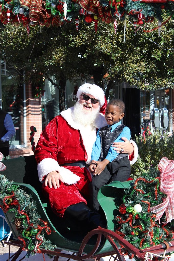 Santa Clause Poses with a fan.