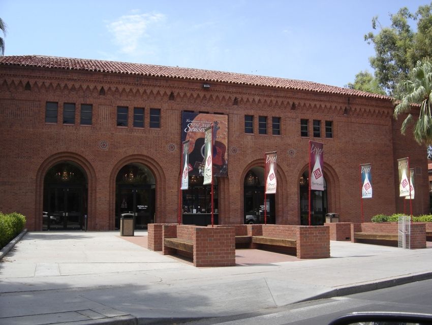 Front of building with walkway that supports various flags